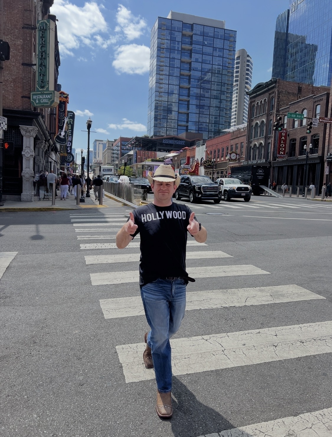 Stephen walking a Nashville crosswalk wearing his HOLLYWOOD shirt and cowboy hat