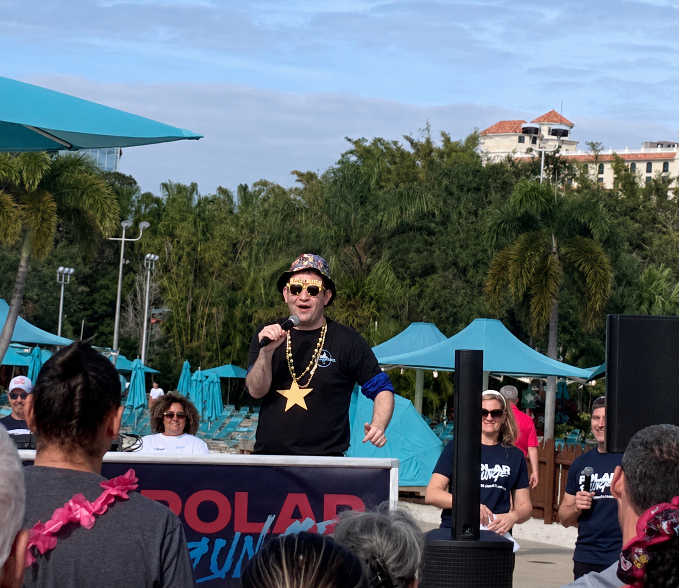 Stephen speaking into a microphone on stage at the Special Olympics Polar Plunge