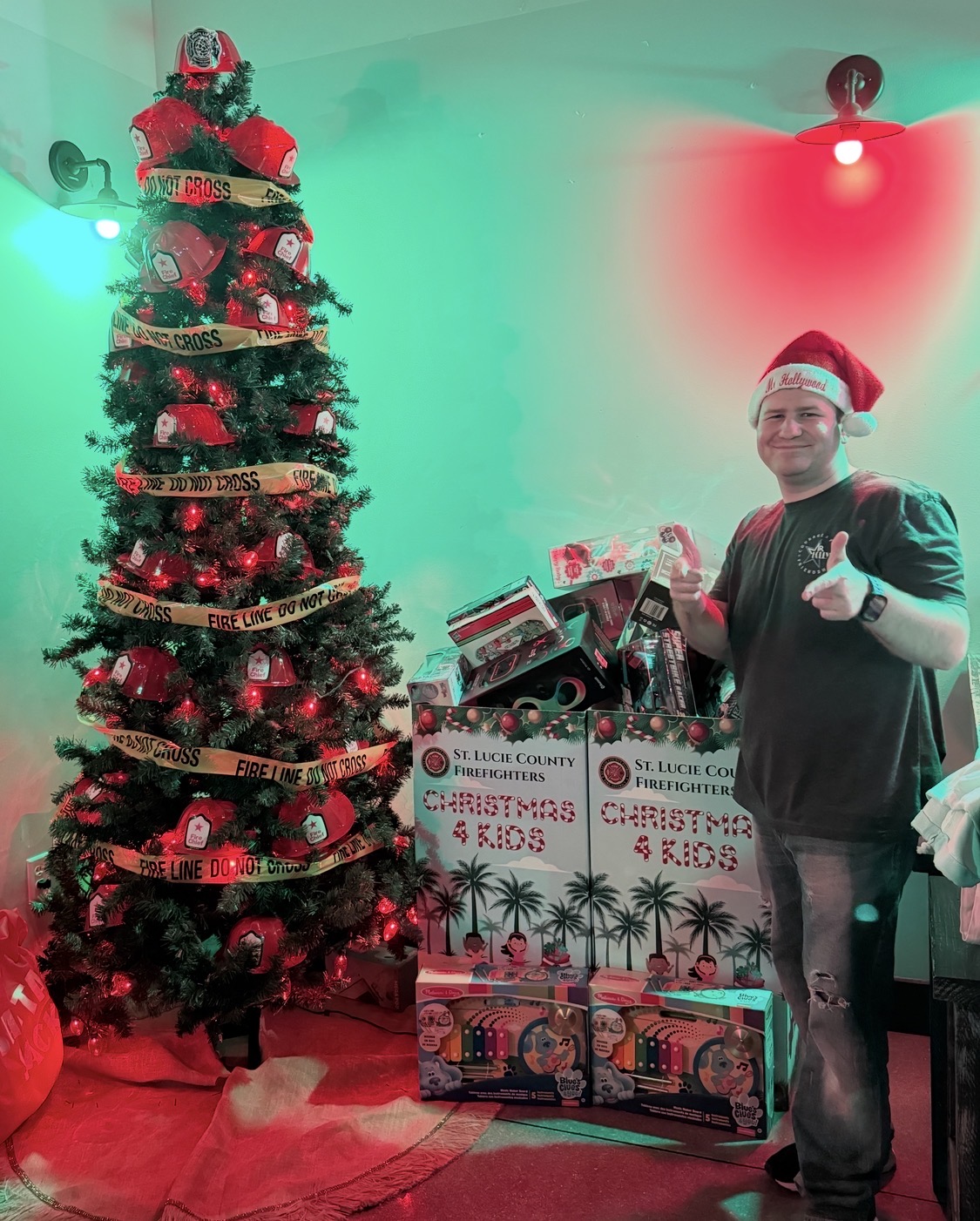 Stephen Lepore beside filled St. Lucie County Firefighters Christmas 4 Kids donation boxes